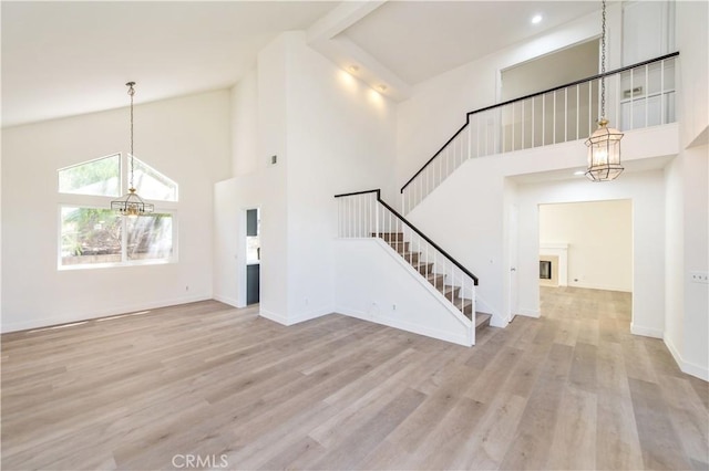 3314 Braemar Ln, Corona, CA 92882 - entryway with a chandelier, stairway, high vaulted ceiling, and wood finished floors