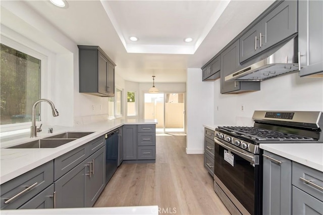 3314 Braemar Ln, Corona, CA 92882 - kitchen with appliances with stainless steel finishes, under cabinet range hood, light wood finished floors, recessed lighting, and a tray ceiling