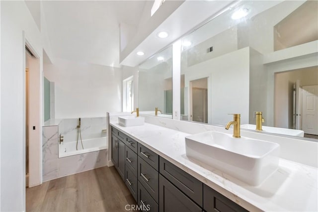 3314 Braemar Ln, Corona, CA 92882 - full bath featuring a garden tub, double vanity, wood finished floors, and recessed lighting