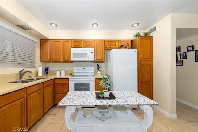 28851 Murrieta Rd, Menifee, CA 92586 - kitchen with white appliances, brown cabinetry, and light tile patterned flooring