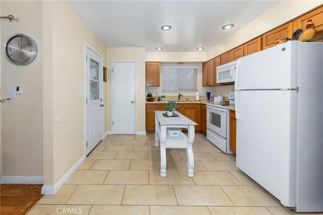 28851 Murrieta Rd, Menifee, CA 92586 - kitchen with white appliances, light countertops, recessed lighting, brown cabinets, and light tile patterned flooring