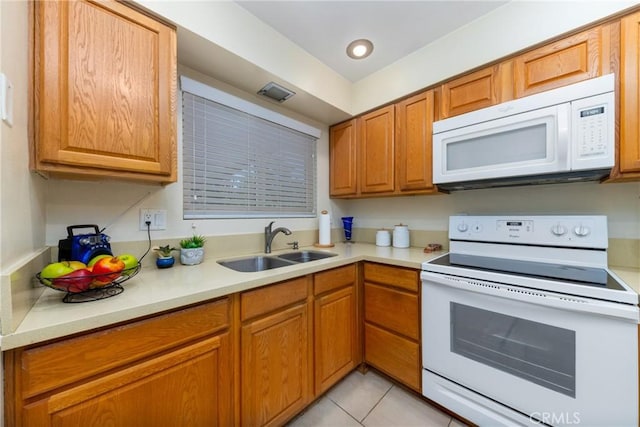 28851 Murrieta Rd, Menifee, CA 92586 - kitchen featuring white appliances, light countertops, brown cabinets, and light tile patterned flooring
