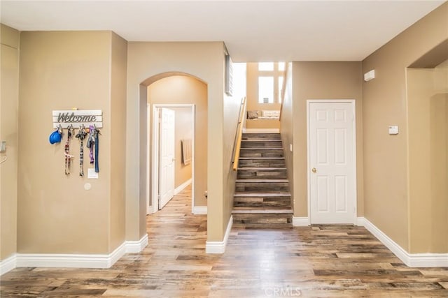 29155 Celestial Dr, Menifee, CA 92584 - stairway featuring wood finished floors and arched walkways