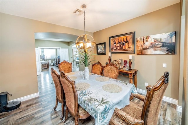 29155 Celestial Dr, Menifee, CA 92584 - dining area with a chandelier, arched walkways, and wood finished floors