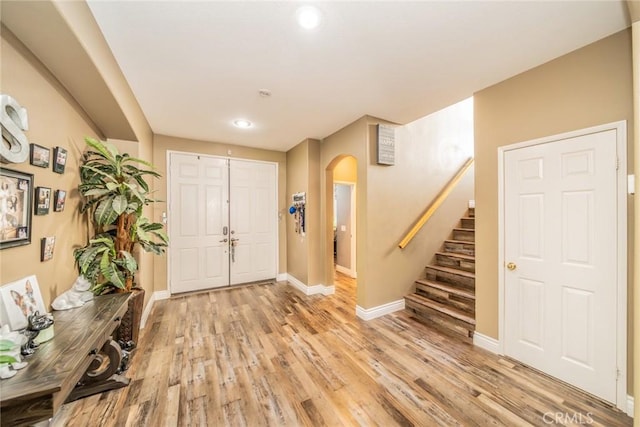 29155 Celestial Dr, Menifee, CA 92584 - foyer entrance with arched walkways, light wood finished floors, stairs, and recessed lighting