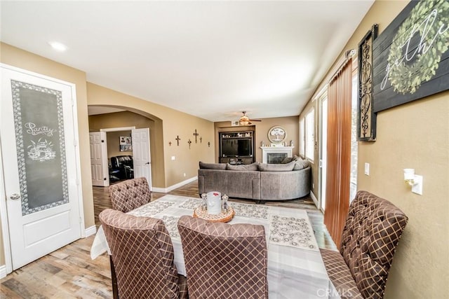 29155 Celestial Dr, Menifee, CA 92584 - dining area with light wood-type flooring, arched walkways, and ceiling fan