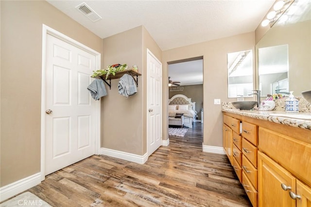 29155 Celestial Dr, Menifee, CA 92584 - full bath with connected bathroom, wood finished floors, vanity, and a ceiling fan
