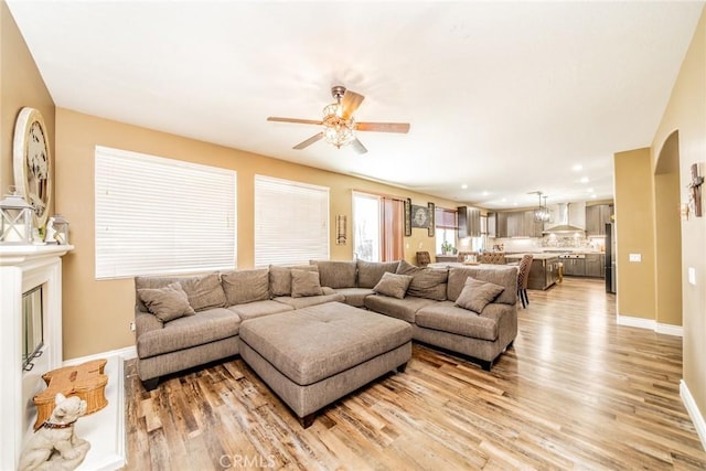 29155 Celestial Dr, Menifee, CA 92584 - living area with light wood-style floors, ceiling fan, arched walkways, and recessed lighting