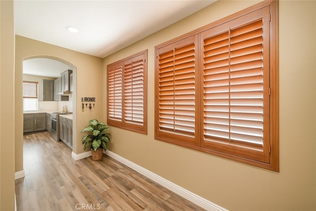 29155 Celestial Dr, Menifee, CA 92584 - hallway featuring arched walkways, light wood-style floors, and recessed lighting