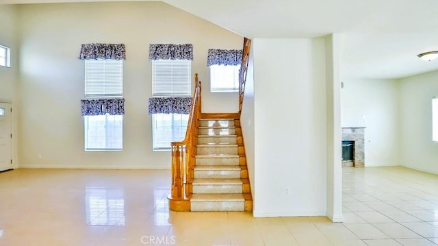 15537 Pheasant St, Chino Hills, CA 91709 - stairway with tile patterned flooring, plenty of natural light, and a fireplace