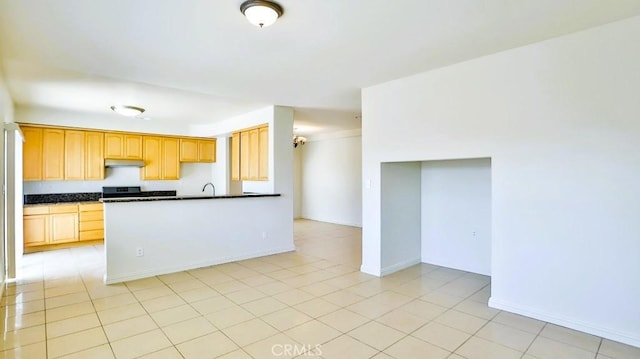 15537 Pheasant St, Chino Hills, CA 91709 - kitchen featuring dark countertops, under cabinet range hood, range, a peninsula, and light tile patterned floors