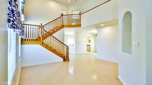 15537 Pheasant St, Chino Hills, CA 91709 - stairs featuring arched walkways, recessed lighting, a high ceiling, and tile patterned floors