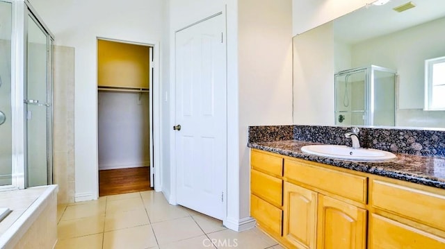 15537 Pheasant St, Chino Hills, CA 91709 - bathroom featuring a stall shower, vanity, tile patterned flooring, and a walk in closet