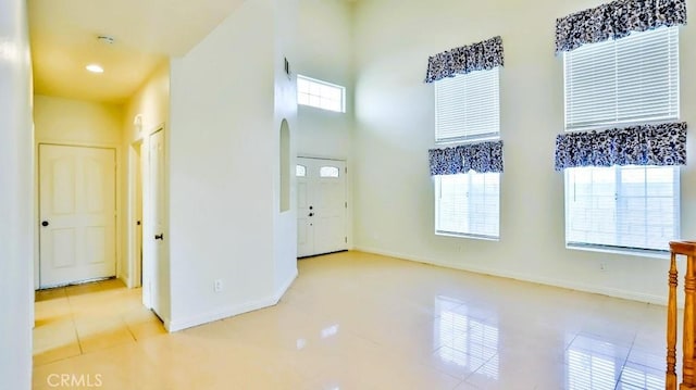 15537 Pheasant St, Chino Hills, CA 91709 - tiled spare room featuring arched walkways, a towering ceiling, and recessed lighting