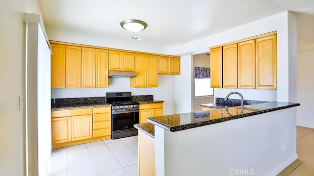 15537 Pheasant St, Chino Hills, CA 91709 - kitchen with stainless steel gas stove, dark stone counters, light tile patterned floors, a peninsula, and under cabinet range hood