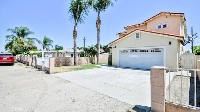 15537 Pheasant St, Chino Hills, CA 91709 - mediterranean / spanish-style house featuring a gate, stucco siding, driveway, a tile roof, and a garage
