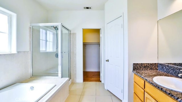 15537 Pheasant St, Chino Hills, CA 91709 - bathroom featuring a shower stall, vanity, tile patterned floors, a garden tub, and a spacious closet