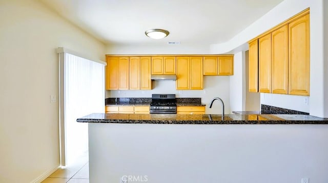 15537 Pheasant St, Chino Hills, CA 91709 - kitchen with stainless steel range with gas cooktop, dark stone countertops, a peninsula, under cabinet range hood, and light tile patterned flooring