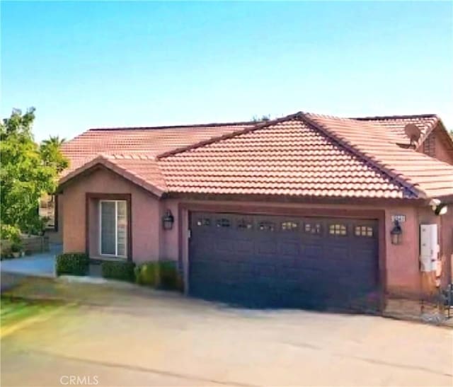 12649 Mesa Linda Ave, Victorville, CA 92392 - view of front of home with an attached garage, concrete driveway, and stucco siding
