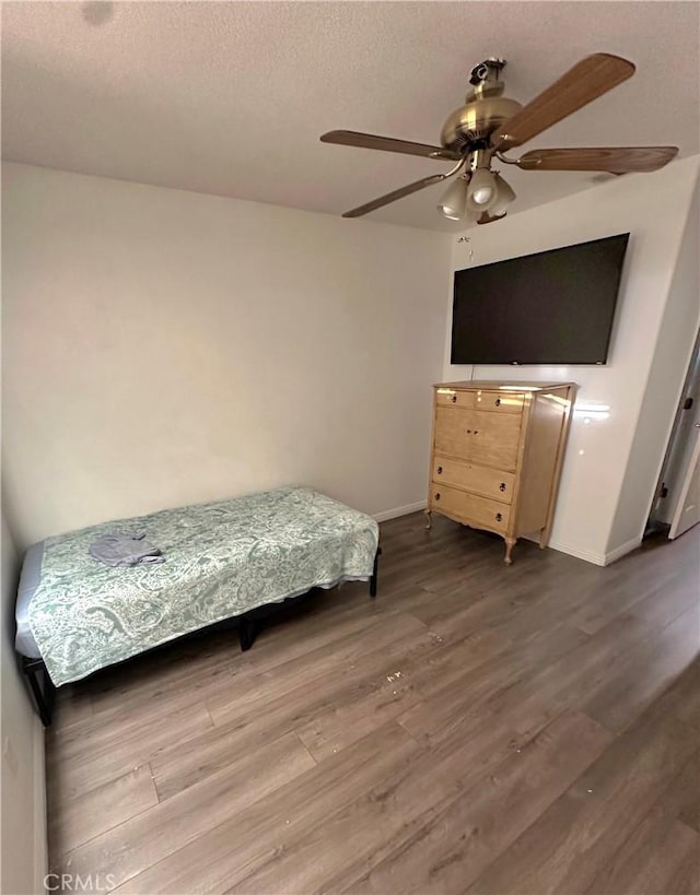 12649 Mesa Linda Ave, Victorville, CA 92392 - bedroom with wood finished floors, a ceiling fan, and a textured ceiling