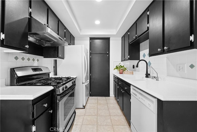 1456 Countrywood Ave Unit 14, Hacienda Heights, CA 91745 - kitchen featuring white dishwasher, stainless steel gas stove, dark cabinetry, and range hood