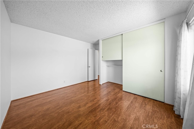 1456 Countrywood Ave Unit 14, Hacienda Heights, CA 91745 - unfurnished bedroom with a textured ceiling, wood finished floors, and a closet