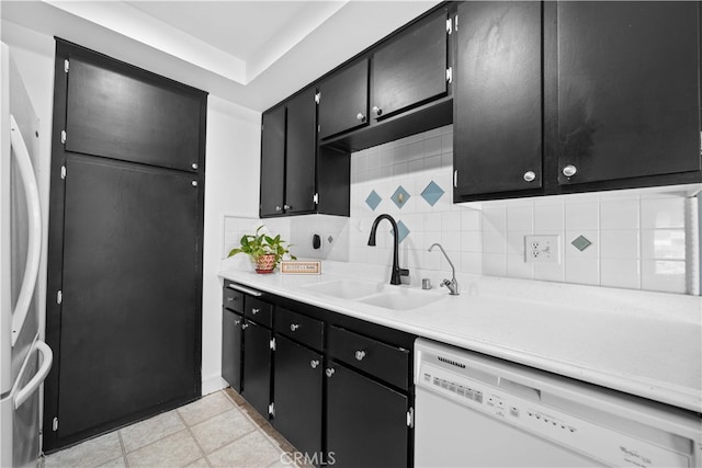 1456 Countrywood Ave Unit 14, Hacienda Heights, CA 91745 - kitchen with white dishwasher, dark cabinetry, fridge, tasteful backsplash, and light countertops