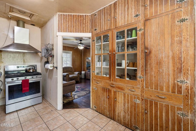 1955 Glen Ave, Pasadena, CA 91103 - kitchen featuring gas range, wall chimney exhaust hood, wooden walls, and ceiling fan