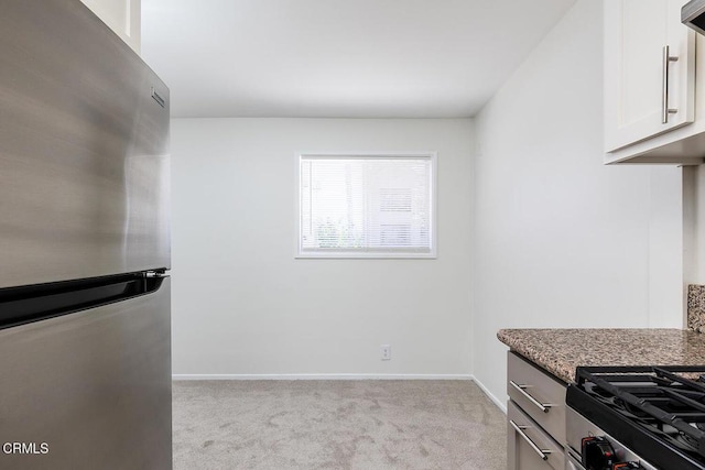 837 Magnolia Ave Unit 12, Pasadena, CA 91106 - kitchen featuring freestanding refrigerator, light colored carpet, stone countertops, and white cabinets
