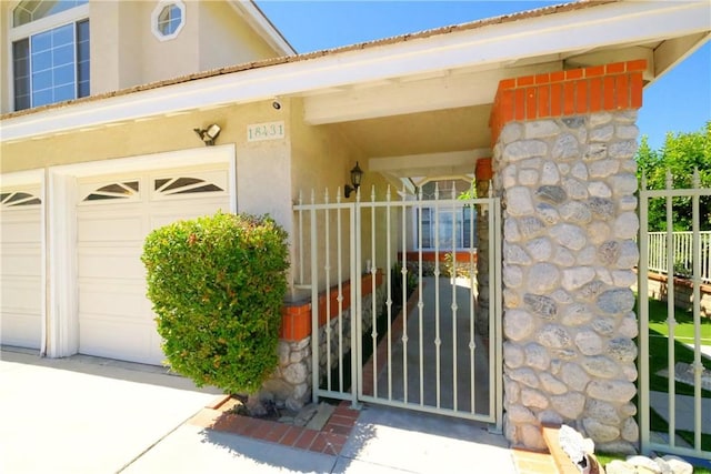 18431 Dancy St, Rowland Heights, CA 91748 - view of exterior entry featuring stucco siding, a gate, and concrete driveway