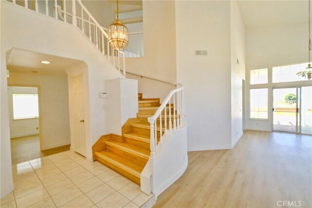 18431 Dancy St, Rowland Heights, CA 91748 - staircase with a towering ceiling, a chandelier, and tile patterned floors