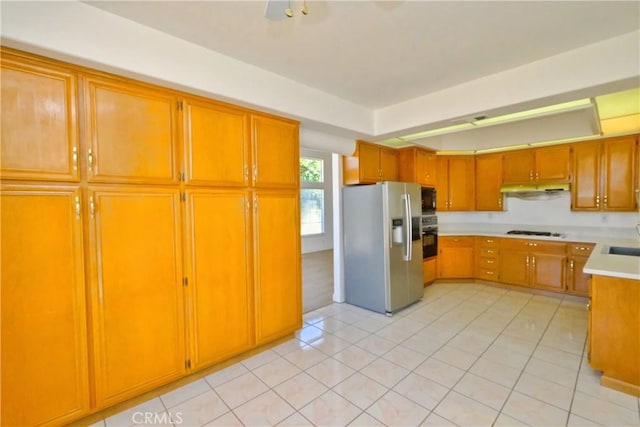 18431 Dancy St, Rowland Heights, CA 91748 - kitchen featuring black appliances, under cabinet range hood, light countertops, light tile patterned flooring, and brown cabinetry