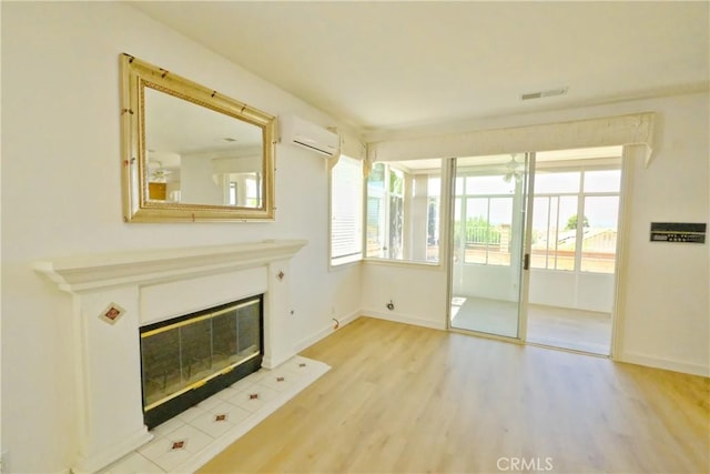 18431 Dancy St, Rowland Heights, CA 91748 - unfurnished living room featuring a wall mounted AC, light wood-style flooring, and a glass covered fireplace