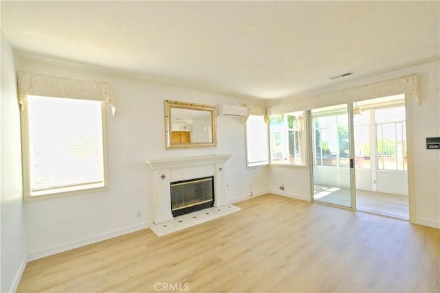 18431 Dancy St, Rowland Heights, CA 91748 - unfurnished living room with light wood-type flooring, a wall mounted AC, and a glass covered fireplace