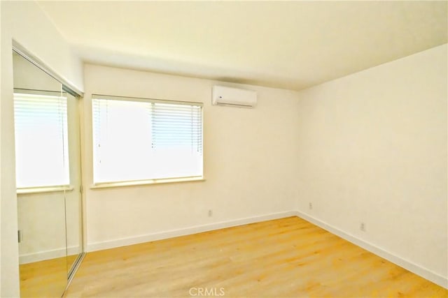 18431 Dancy St, Rowland Heights, CA 91748 - unfurnished room with an AC wall unit and light wood-type flooring