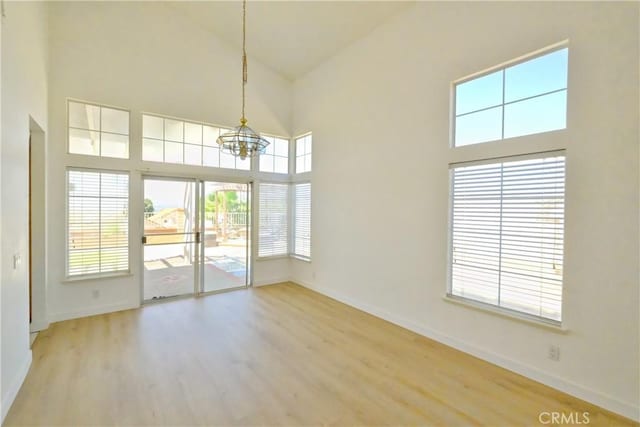 18431 Dancy St, Rowland Heights, CA 91748 - unfurnished dining area featuring high vaulted ceiling, a chandelier, and wood finished floors