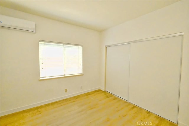 18431 Dancy St, Rowland Heights, CA 91748 - unfurnished bedroom with a wall unit AC, light wood finished floors, and a closet