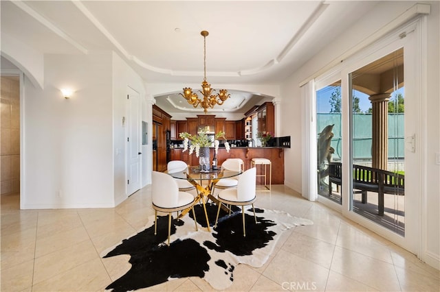 4642 Ohio St, Yorba Linda, CA 92886 - dining space with a tray ceiling, light tile patterned floors, a chandelier, and arched walkways