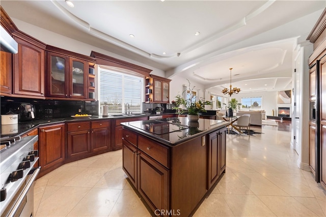 4642 Ohio St, Yorba Linda, CA 92886 - kitchen featuring range, a chandelier, decorative backsplash, light tile patterned floors, and a kitchen island