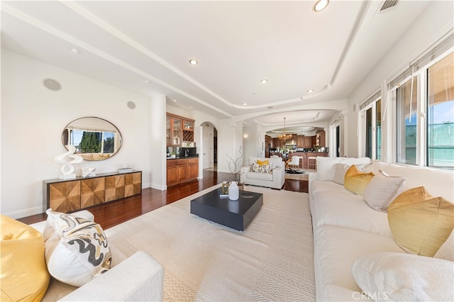 4642 Ohio St, Yorba Linda, CA 92886 - living room featuring arched walkways, dark wood finished floors, recessed lighting, and a raised ceiling
