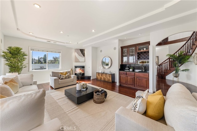 4642 Ohio St, Yorba Linda, CA 92886 - living room featuring stairway, recessed lighting, dark wood-style flooring, a raised ceiling, and a glass covered fireplace