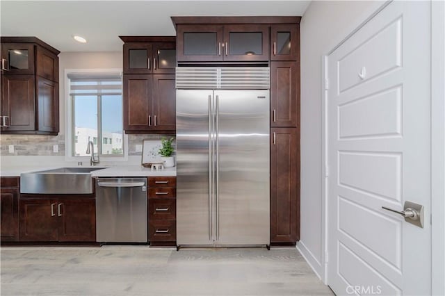 195 Stellar, Irvine, CA 92618 - kitchen featuring appliances with stainless steel finishes, light countertops, dark brown cabinets, tasteful backsplash, and recessed lighting