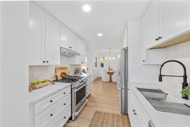 13141 Willamette St, Westminster, CA 92683 - kitchen featuring appliances with stainless steel finishes, under cabinet range hood, white cabinets, light countertops, and recessed lighting
