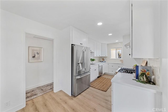 13141 Willamette St, Westminster, CA 92683 - kitchen with appliances with stainless steel finishes, light wood-type flooring, white cabinets, light countertops, and recessed lighting