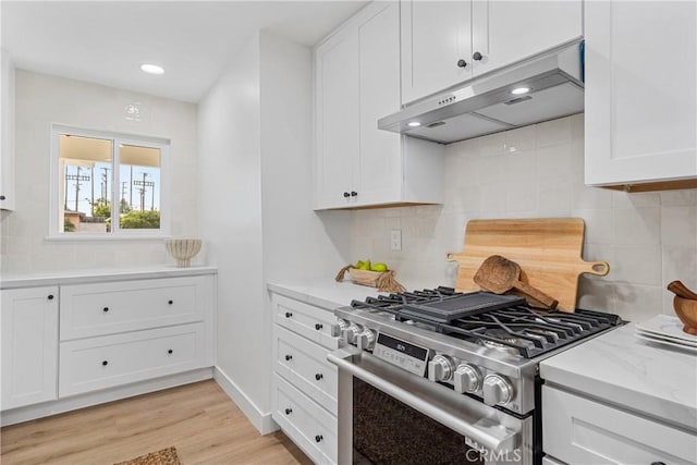 13141 Willamette St, Westminster, CA 92683 - kitchen with gas stove, under cabinet range hood, white cabinetry, decorative backsplash, and recessed lighting
