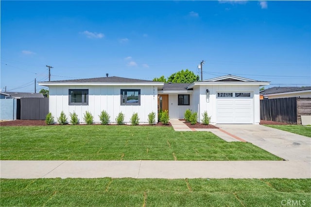 13141 Willamette St, Westminster, CA 92683 - view of front of home with board and batten siding, a garage, and driveway