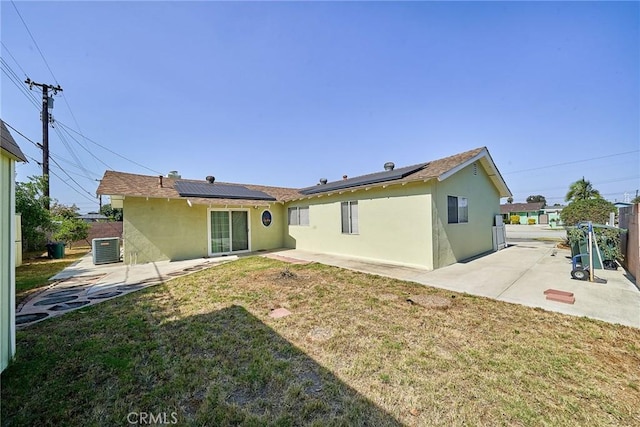 7961 La Corona Way, Buena Park, CA 90620 - back of property with a patio area, stucco siding, and solar panels