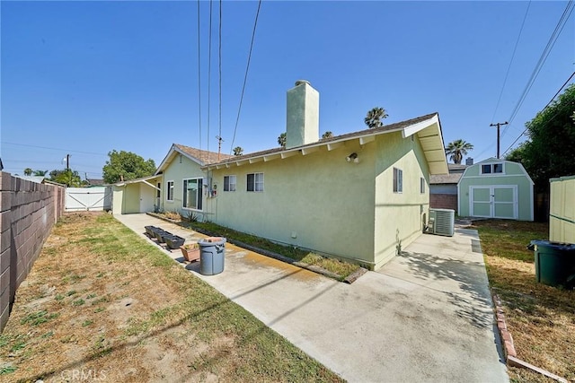 7961 La Corona Way, Buena Park, CA 90620 - back of property with a shed, stucco siding, a chimney, and a patio