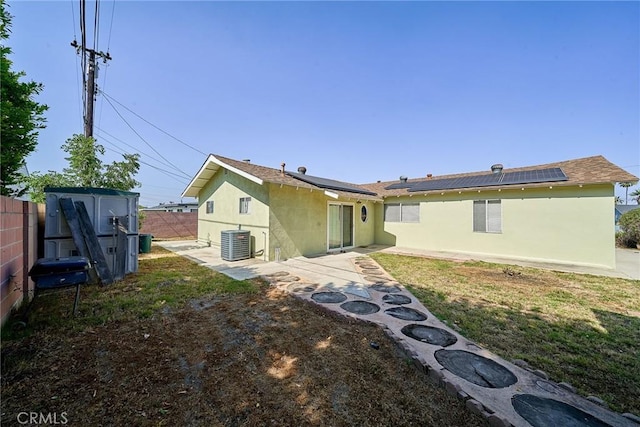 7961 La Corona Way, Buena Park, CA 90620 - rear view of house with a shed, a fenced backyard, a patio area, roof mounted solar panels, and stucco siding