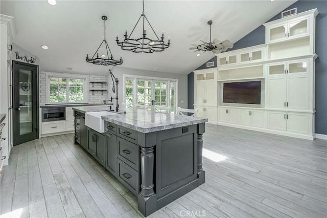 777 Oak Knoll St, Brea, CA 92821 - kitchen featuring lofted ceiling, gray cabinets, light wood-type flooring, recessed lighting, and a chandelier